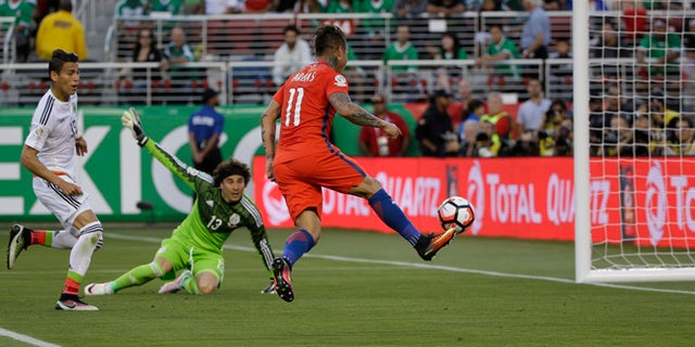 CORRECTS THAT THERE WAS NO GOAL, AS OFFSIDE WAS CALLED - Chileâs Eduardo Vargas hits the ball toward the goal against Mexico, but offside was called, during a Copa America Centenario soccer quarterfinal in Santa Clara, Calif., Saturday, June 18, 2016. (AP Photo/ Marcio Jose Sanchez)