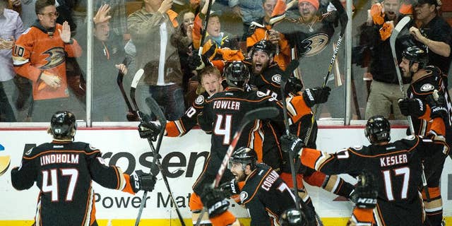 corrects name of the photographerAnaheim Ducks' Corey Perry (10), rear left, celebrates his game-winning goal for a 3-2 overtime win against Calgary in Game 5 of a second-round series in the NHL hockey playoffs in Anaheim, Calif., Sunday, May 10, 2015. Anaheim eliminated Calgary and will face the Chicago Blackhawks in the Western Conference finals. (Kyusung Gong/The Orange County Register via AP) LA TIMES OUT MAGS