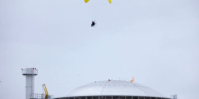 May 2, 2012: In this photo provided by Greenpeace, an activist in a motorized paraglider flies over the Bugey nuclear power plant, near Saint-Vulbas, central France, and drops a flare on the roof.