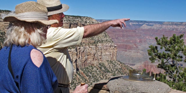 Karen and Tom Jacobs, of Carrollton, Texas, look out over the South Rim of the Grand Canyon on Monday, Sept. 30, 2013.