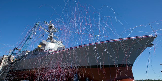 Streamers fly during the christening the USS Rafael Peralta on Saturday, Oct. 31, 2015, in Bath, Maine