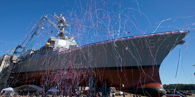 Streamers fly during the christening the USS Rafael Peralta on Saturday, Oct. 31, 2015, in Bath, Maine