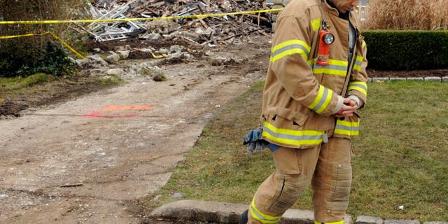 December 27: Stamford firefighter Nick Tamburro pays respect outside the home of Madonna Badger in Stamford, Connecticut. A fire at the home on Christmas morning killed Badger’s three daughters and parents.
