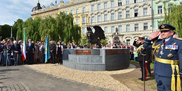 The monument in memory of Czechoslovak WWII pilots in the British Royal Air Force (RAF), which is opposed by heritage protectors, was unveiled in a park in Prague centre, Tuesday, June 17, 2014. The two-metre bronze statue of a winged lion, made by British sculptor Colin Spofforth, stands on a concrete plinth. It was donated by the British community living in the Czech Republic. (AP Photo/CTK, Vit Simanek) SLOVAKIA OUT