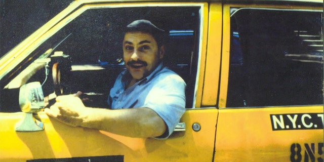 Jerry Torre, also known as the "Marble Faun," driving a taxi in New York City.