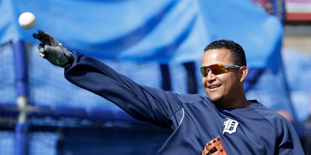 Miguel Cabrera plays catch before batting practice during spring training.