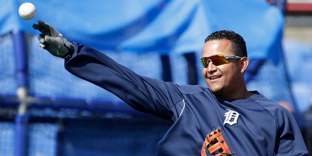 Miguel Cabrera plays catch before batting practice during spring training.