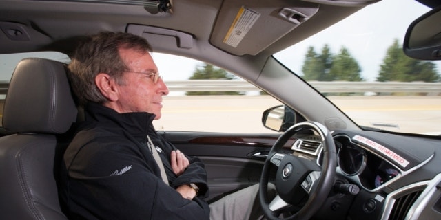 General Motors Staff Researcher Dr. Jeremy Salinger road tests a Cadillac semi-autonomous driving technology it calls “Super Cruise” that is capable of fully automatic steering, braking and lane-centering in highway driving under certain optimal conditions Friday, March 23, 2012 in Milford, Michigan. Super Cruise is designed to ease the driver’s workload on the freeway, in both bumper-to-bumper traffic and on long road trips by relying on a fusion of radar, ultrasonic sensors, cameras and GPS map data. The system could be ready for production vehicles by mid-decade. (Photo by John F. Martin for Cadillac)