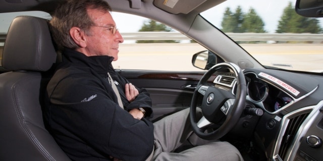 General Motors Staff Researcher Dr. Jeremy Salinger road tests a Cadillac semi-autonomous driving technology it calls “Super Cruise” that is capable of fully automatic steering, braking and lane-centering in highway driving under certain optimal conditions Friday, March 23, 2012 in Milford, Michigan. Super Cruise is designed to ease the driver’s workload on the freeway, in both bumper-to-bumper traffic and on long road trips by relying on a fusion of radar, ultrasonic sensors, cameras and GPS map data. The system could be ready for production vehicles by mid-decade. (Photo by John F. Martin for Cadillac)