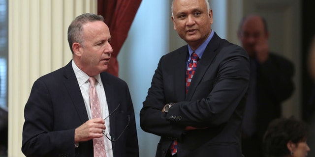 Senate President Pro Tem Darrell Steinberg, D-Sacramento, left, talks with Sen. Ed Hernandez, D-Covina at the Capitol in Sacramento, Calif., Monday, April 21, 2014. Hernandez proposed a constitutional amendment that would ask voters to again allow public colleges to use race and ethnicity when considering college applicants. The proposal stalled this year after backlash from Asian Americans.(AP Photo/Rich Pedroncelli)