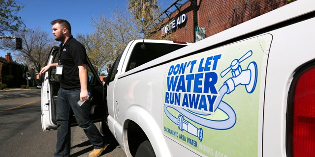 March 11, 2014: Steve Upton, an inspector for the water conservation unit for the Sacramento Utilities department, climbs out of his truck to make an inspection of an alleged water waste while making his rounds in Sacramento, Calif.  At least 45 water agencies throughout California have imposed mandatory restrictions on water use as their supplies run dangerously low. (AP Photo/Rich Pedroncelli)