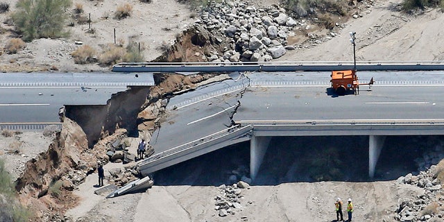 This aerial photo shows the collapsed elevated section of Interstate 10, Monday, July 20, 2015, in Desert Center, Calif. All traffic along one of the major highways connecting California and Arizona was blocked indefinitely when the bridge over a desert wash collapsed during a major storm, and the roadway in the opposite direction sustained severe damage. (AP Photo/Matt York)
