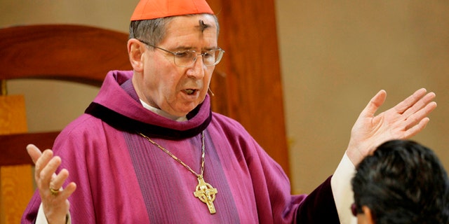 FILE - In this Feb. 6, 2008 file photo, Cardinal Roger Mahony officiates during Ash Wednesday services at the Cathedral of Our Lady of the Angels in Los Angeles. The Roman Catholic Archdiocese of Los Angeles will pay $13 million to settle 17 clergy abuse lawsuits, including 11 that involve a visiting Mexican priest who fled prosecution and remains a fugitive more than 25 years later, plaintiffs' attorneys said Tuesday Feb. 18, 2014. (AP Photo/Nick Ut, File)