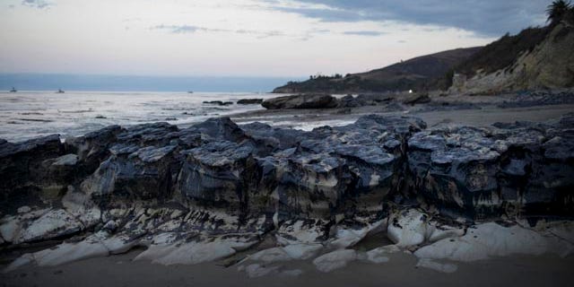 May 21, 2015: Rocks are covered with oil on the beach at Refugio State Beach, north of Goleta, Calif. (AP Photo/Jae C. Hong)