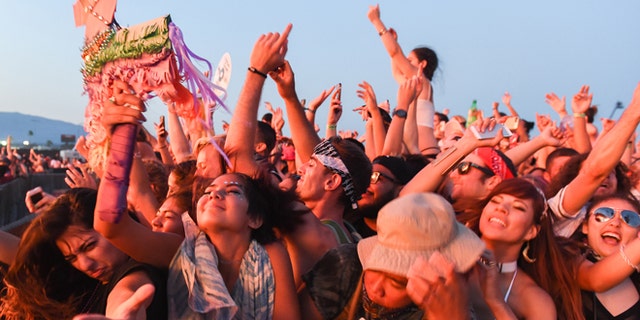 In this Sunday, July 31, 2016, photo, people attend the HARD Summer Music Festival at the Auto Club Speedway in Fontana, Calif. Authorities say multiple people died after attending the weekend rave. (John Valenzuela/The Sun via AP)