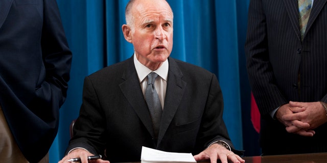File: California Gov. Jerry Brown signs the state budget on June 30.