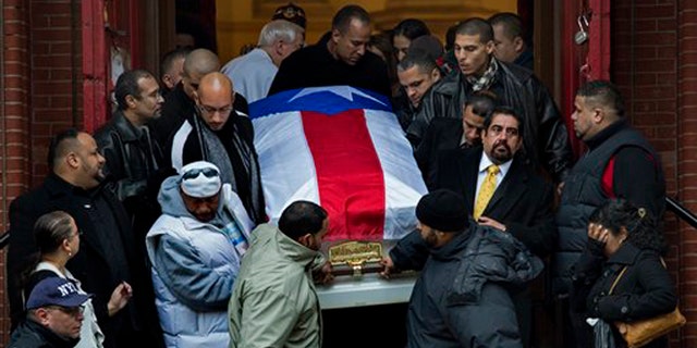Hector "Macho" Camacho's casket is brought down the steps of St. Cecilia's Roman Catholic Church in New York after his funeral Saturday, Dec. 1, 2012. (AP Photo/Craig Ruttle)