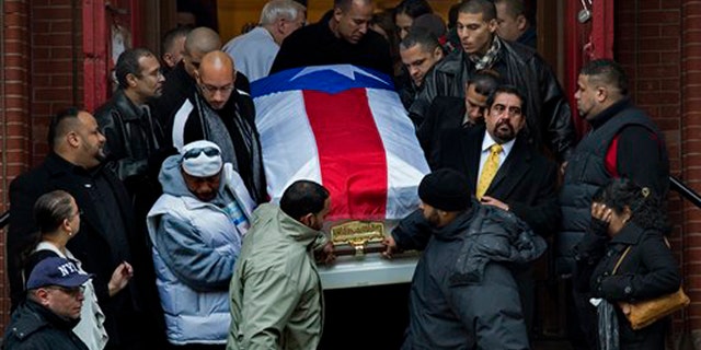 Hector "Macho" Camacho's casket is brought down the steps of St. Cecilia's Roman Catholic Church in New York after his funeral Saturday, Dec. 1, 2012. (AP Photo/Craig Ruttle)