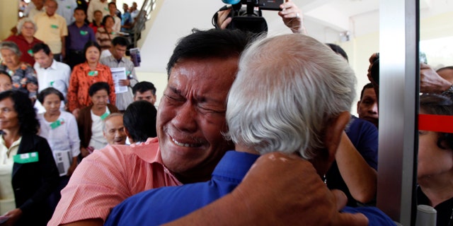August 7, 2014: Cambodian former Khmer Rouge servitors, Soum Rithy, left, cries as he hugs Chum Mey, right, after the verdicts were announced, at the U.N.-backed war crimes tribunal in Phnom Penh. Three and a half decades after the genocidal rule of Cambodia's Khmer Rouge ended, the tribunal on Thursday sentenced two top leaders of the former regime to life in prison on war crimes charges for their role in the country's terror period in the 1970s. (AP Photo/Heng Sinith)
