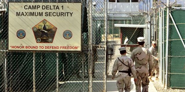 U.S. military guards walk within Camp Delta military-run prison, at the Guantanamo Bay U.S. Naval Base, Cuba.