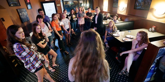 In this photo taken Sept. 7, 2016, University of Iowa students listen during a Hillary Clinton for President organizing event in Iowa City, Iowa. The Clinton campaign is working in about a dozen battleground states as their aggressive voter turnout apparatus kicks into high gear for the sprint to Election Day. In Iowa alone, 25,000 volunteers are helping send real-time data on voters back to the campaignââ¬â¢s Brooklyn headquarters, where dozens of analysts model the electorate .(AP Photo/Charlie Neibergall)