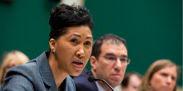 FILE: Oct. 24, 2013: Cheryl Campbell, Senior vice president of CGI Federal, left, testifies on Capitol Hill in Washington. D.C.