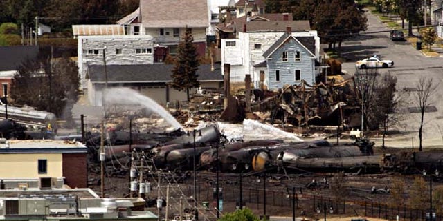 July 8, 2013: Wreckage is strewn through the downtown core in Lac-Megantic, Quebec after a train derailed, igniting tanker cars carrying crude oil early Saturday.