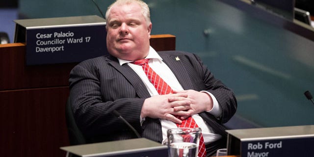 November 18, 2013: Toronto Mayor Rob Ford sits in the council chamber as Councillors look to pass motions to limit his powers. Ford called the effort a "coup d'etat" and challenged the council to call snap elections. (AP Photo/The Canadian Press, Chris Young)