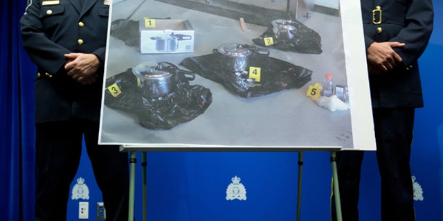 July 2, 2013: An evidence photo showing a set of pressure cookers is displayed during a news conference  in Surrey, B.C.. Police have arrested a Canadian man and a woman and charged them as terrorist suspects for attempting to leave a suspicious package at British Columbia's provincial legislature on Canada Day.
