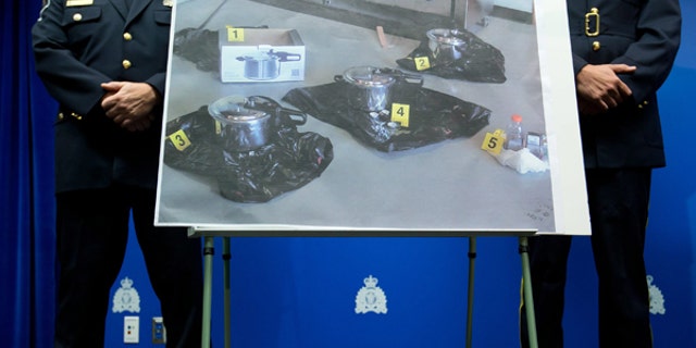 July 2, 2013: An evidence photo showing a set of pressure cookers is displayed during a news conference in Surrey, B.C.. Police have arrested a Canadian man and a woman and charged them as terrorist suspects for attempting to leave a suspicious package at British Columbia's provincial legislature on Canada Day.