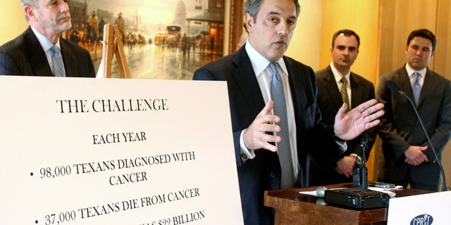 In this Jan. 20, 2009, file photo, the Cancer Prevention and Research Institute of Texas chairman James Mansour, center, announces the release of $60 million in grants for cancer research projects in Texas during a news conference in Austin, Texas. Leaders at the Cancer Prevention and Research Institute of Texas say they hope to begin soliciting new applications for research grants by October 2013 after a year of turmoil and an ongoing criminal investigation into questionable grant awards.