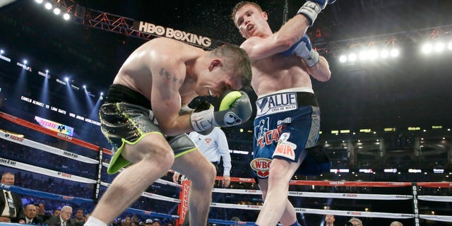 Canelo Alvarez punches Liam Smith during the eight round of the WBO Junior Middleweight championship boxing match at the stadium in Arlington, Texas, Saturday, Sept. 17, 2016. Alvarez won with a knock out in the ninth round. (AP Photo/LM Otero)