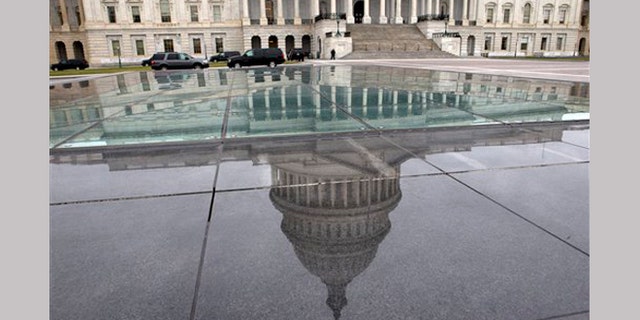 FILE - In this Tuesday, Jan. 1, 2013, file photo, the dome of the Capitol is reflected in a skylight of the Capitol Visitor's Center in Washington.