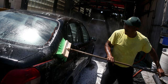 SAN MATEO, CA - JULY 29: A worker uses a brushe to clean a car at Ducky's Car Wash on July 29, 2015 in San Mateo, California. As California endures its fourth year of severe drought and state water officials have implemented mandatory water reductions, San Mateo County Health System officials are encouraging residents to have their cars washed by a local professional car wash instead of washing your car at home with a garden hose. Most professional car washes use recycled water and average about 20 gallons or less per wash versus up to 150 gallons for a home wash. (Photo by Justin Sullivan/Getty Images)