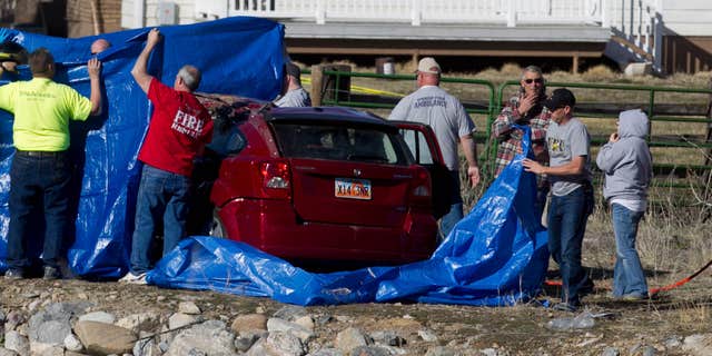 March 7, 2015: Officials respond to a report of car in the Spanish Fork River near the Main Street and the Arrowhead Trail Road junction in Spanish Fork, Utah.