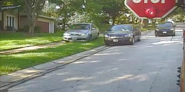 A Missouri man hsa been accused of driving onto a sidewalk while a school bus was stopped to pick up children.