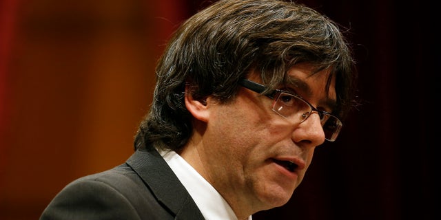Incoming Catalan President Carles Puigdemont speaks during the investiture session at the Catalonian parliament in Barcelona, Spain, Sunday, Jan. 10, 2016. Catalonia's pro-independence parties have agreed to appoint a new leader to enable the creation of a regional coalition government and reinvigorate a push for independence from Spain by 2017. Carles Puigdemont was selected Saturday to replace Artur Mas as the "Together for Yes" alliance's candidate for regional government leader. (AP Photo/Manu Fernandez)