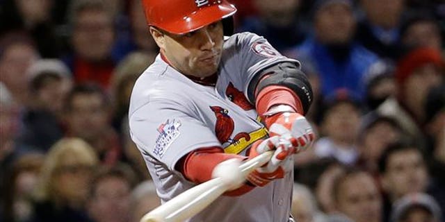 FILE - In this Oct. 24, 2013, file photo, St. Louis Cardinals' Carlos Beltran hits an RBI single during Game 2 of baseball's World Series against the Boston Red Sox in Boston. Two people familiar with the negotiations say outfielder Carlos Beltran and the New York Yankees have agreed to a $45 million, three-year contract. (AP Photo/David J. Phillip, File)