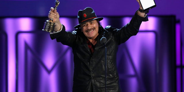 Musician Carlos Santana accepts the Outstanding Commitment to Cause and Community Award at the 2013 NCLR ALMA Awards at the Pasadena Civic Auditorium in Pasadena, California September 27, 2013.