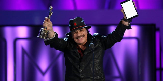Musician Carlos Santana accepts the Outstanding Commitment to Cause and Community Award at the 2013 NCLR ALMA Awards at the Pasadena Civic Auditorium in Pasadena, California September 27, 2013.