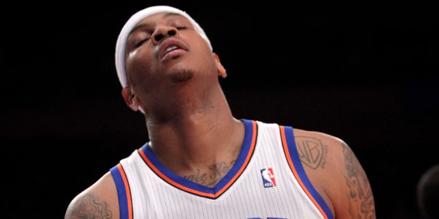 New York Knicks' Carmelo Anthony reacts after missing a shot during the first half of an NBA basketball game against the Philadelphia 76ers in New York, Sunday, March 11, 2012. The 76ers defeated the Knicks 106-94. (AP Photo/Seth Wenig)