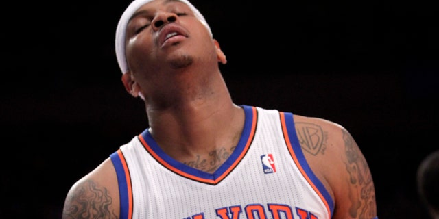 New York Knicks' Carmelo Anthony reacts after missing a shot during the first half of an NBA basketball game against the Philadelphia 76ers in New York, Sunday, March 11, 2012. The 76ers defeated the Knicks 106-94. (AP Photo/Seth Wenig)