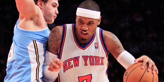 New York Knicks' Carmelo Anthony  drives past Denver Nuggets' Danilo Gallinari, of Italy, during the first half of an NBA basketball game Saturday, Jan. 21, 2012, in New York. (AP Photo/Frank Franklin II)