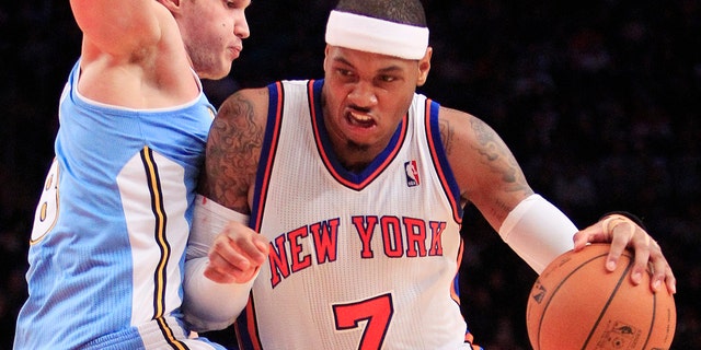 New York Knicks' Carmelo Anthony drives past Denver Nuggets' Danilo Gallinari, of Italy, during the first half of an NBA basketball game Saturday, Jan. 21, 2012, in New York. (AP Photo/Frank Franklin II)