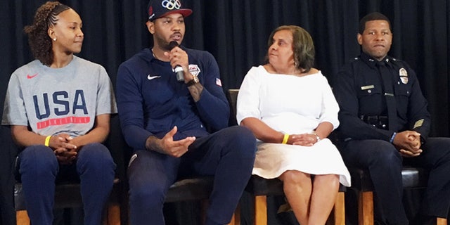 Carmelo Anthony with Tamika Catchings, left, Charisse Bremond Weaver and LAPD Deputy Chief Bill Scott.