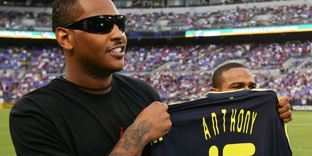 BALTIMORE - JULY 24: NBA player Carmelo Anthony holds up a personalized Chelsea FC jersey before the game between AC Milan and Chelsea FC at M & T Bank Stadium on July 24, 2009 in Baltimore, Maryland. (Photo by Ned Dishman/Getty Images) *** Local Caption *** Carmelo Anthony