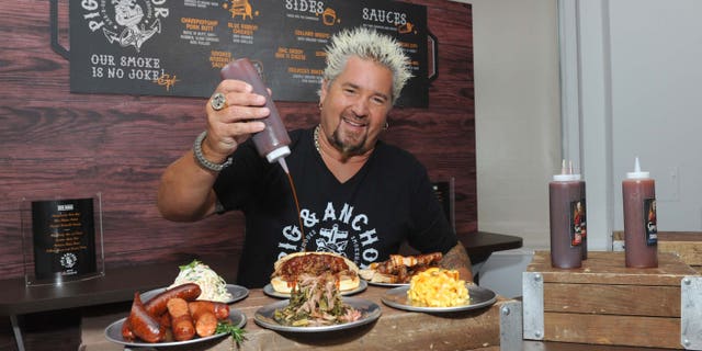 Food Network Star Guy Fieri serves up food from his new Pig & Anchor Bar-B-Que Smokehouse, exclusively on Carnival Cruise Line, at CarnivalÕs Summertime Beer-B-Que, Wednesday, July 27, 2016, in New York. (Diane Bondareff/ AP Images for Carnival Cruise Line)