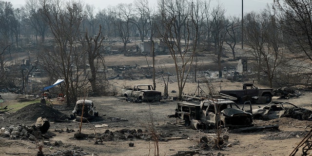 Burned out cars sitting in a neighborhood burned in the Carr Fire are seen on Saturday in Redding.