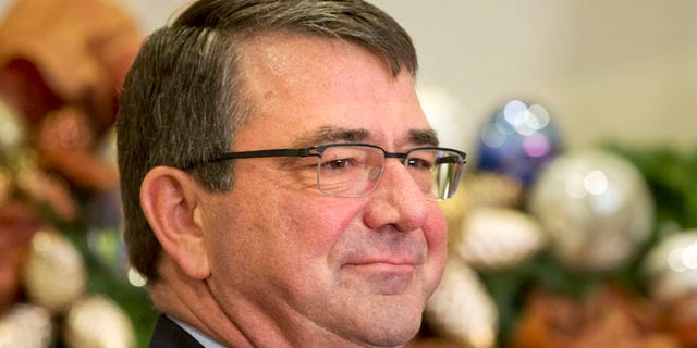 FILE: Dec. 5, 2014: Ashton Carter listen as President Obama announces him as his nominee to be Defense secretary, Roosevelt Room of the White House, Washington, D.C.