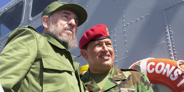Cuban President Fidel Castro (L) and Venezuelan President Hugo Chavez travel onboard a Venezuelan Navy vessel from Porlamar to Pampatar prior a ceremony to promulgate a new Fishing Law, December 11, 2001 at Margarita Island, Venezuela. Castro is in Panpatar to attend the two-day meeting of the Association of Caribbean States (ACS). (Photo by Miraflores/Getty Images)